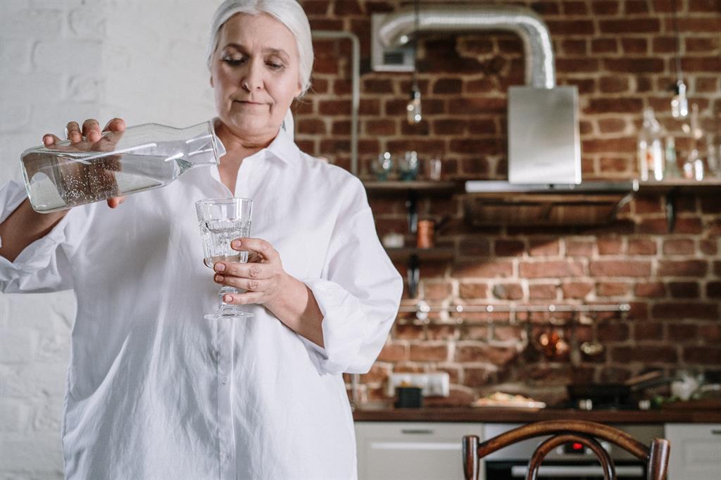 Woman pouring water into a glass